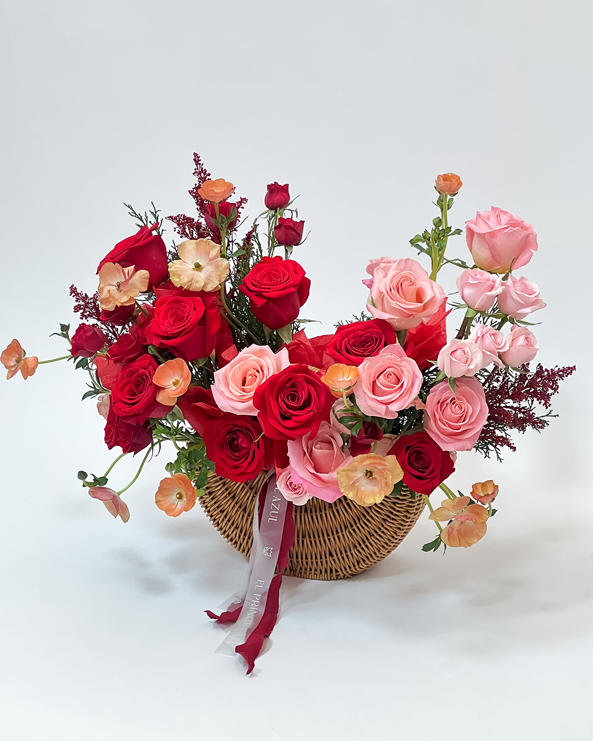SOSPIRO es una Cesta de mimbre para San Valentín que expresa amor con suavidad y distinción. Rosas rojas premium y flores primaverales se unen en una creación romántica, natural y exclusiva de El Príncipe Azul.